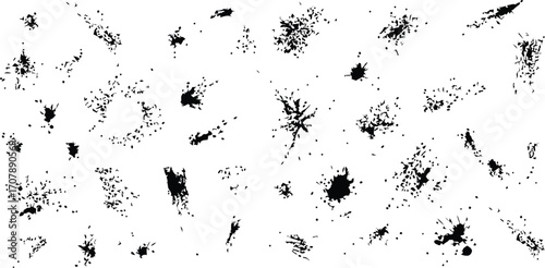 Assorted black ink splatters on a white background surface