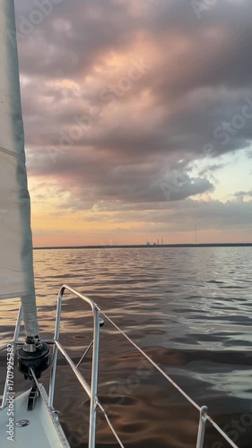 Imagine a Serene Sunset Sailing on Calm Waters, Enhanced by Vibrant and Colorful Clouds