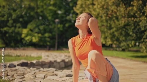 Tourism and relaxation: beautiful little girl enjoying sunny day in park
