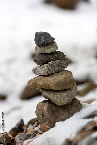 Photography Small stone tower on a snowy day