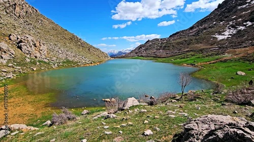Seasonal wetland nestled among rocky hills and green flora, reflecting the sky's peace and the harmony of untouched nature. 📍Sarpir, Hawraman Takht