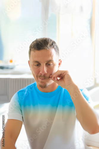 A portrait of a man with moustache in his late 30's.
