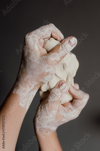 Close up of woman hands molding white clay, creative process