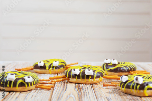 Halloween spider donuts on rustic wooden background