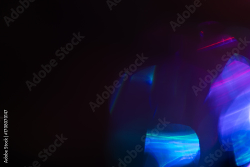 Blurred Light painting one exposure in camera. light glares with a spectral gradient on a dark background.
