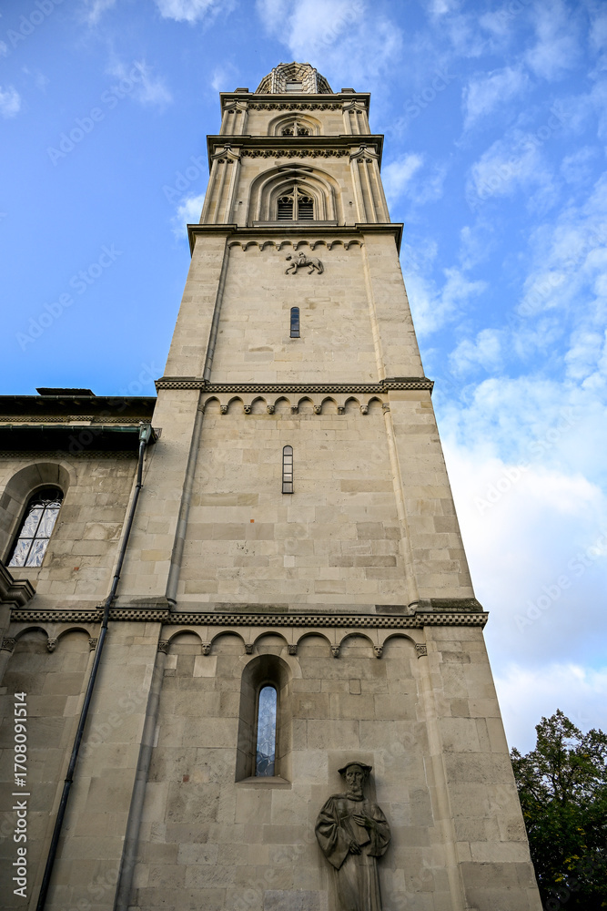 Fototapeta premium Close-up view of Grossmünster twin towers in Zürich, Switzerland, rising against a clear blue sky