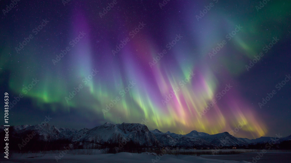 Naklejka premium Medium shot of northern lights glowing in vibrant green and purple waves across a crystal-clear sky, landscape below bathed in luminous light.