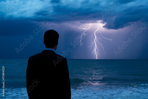 Man in suit watches powerful lightning strike over ocean horizon dramatic sky