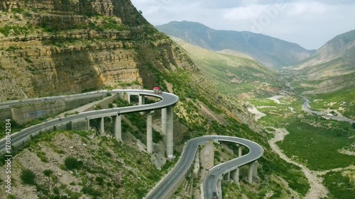 Drone panning over a modern bridge, constructed over a mountain