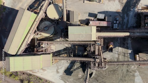 Aerial drone view of huge quarry mining operational facility, extracting rare earth minerals, heavy plant machinery and industrial conveyor belts in Coalville England UK sunny 