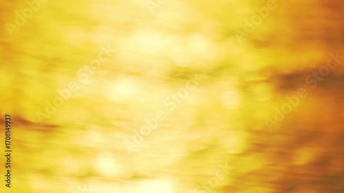 Blurred gold light sunset or sunrise water reflection waves texture nature background