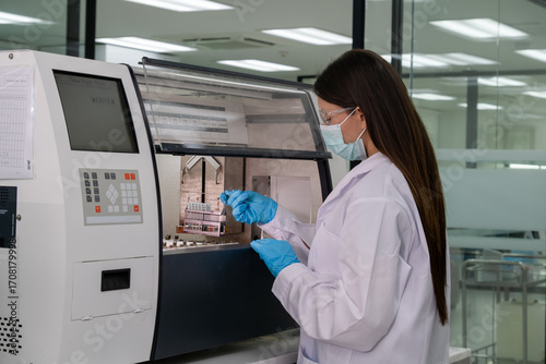 Wallpaper Mural Lab technician conducts an experiment in a modern laboratory wearing protective gear and using advanced equipment Torontodigital.ca