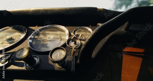 Close-up of a man's hands as he inserts the key into the ignition and starts the car