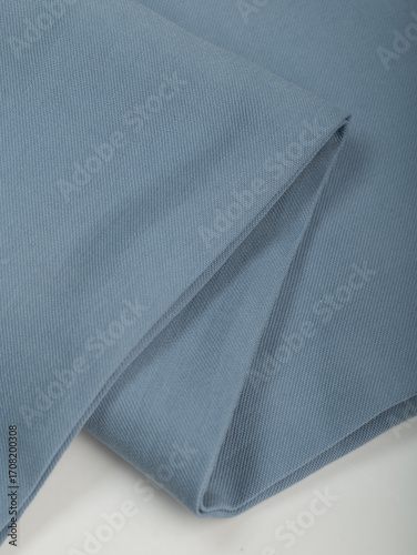 Light blue dense fabric, ironed, the texture of the fabric is visible