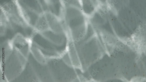 The reflection of water on a white wall.