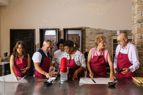 Chefs preparing food in restaurant kitchen during cooking course
