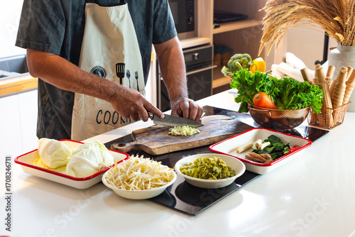 Man Preparing Fresh Vegetables in Kitchen with Healthy Ingredients