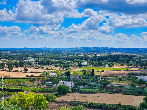 Paysage vioticole. Old village with vineyards. River valley with houses, meadows and trees. Village houses in the fields, small river and mountain range on a background. Paisaje rural.