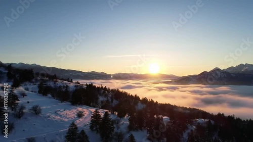 Aerial Sunrise Over Misty Mountain Peaks with Moving Fog (Timelapse Style)