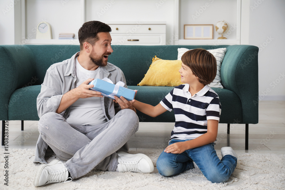 © New Africa - Happy Father's Day. Son giving his dad gift at home © New Africa - Happy Father's Day. Son giving his dad gift at home