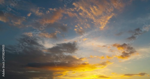 Golden Orange Light Illuminating Stratocumulus Clouds Over Dramatic Sky — 4K Nature Atmosphere Background