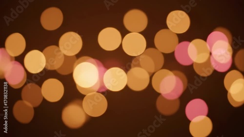 A soft seamlessly looping video displays glowing bokeh light spheres drifting and blurring, creating a gentle and romantic abstract background with subtle motion animation, party, sparkle