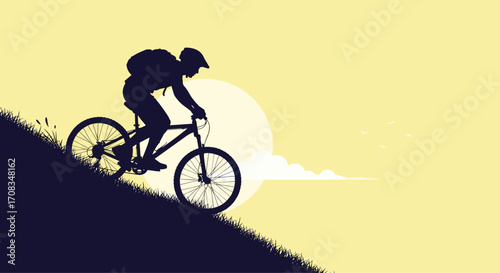 Silhouette of a cyclist riding a mountain bike uphill during sunset.