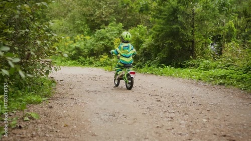 A cheerful kid, wearing a safety helmet, embarks on their first cycling adventure. Emphasizes active family moments and essential protection during early sports.