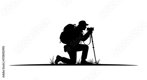 Adventurous photographer kneels to capture stunning landscape with camera and trekking pole