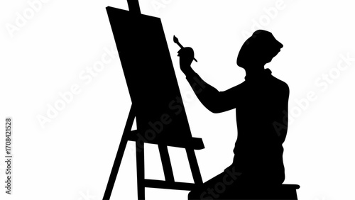 Silhouette of an artist painting on a canvas with an easel in a studio with a brush in their hand