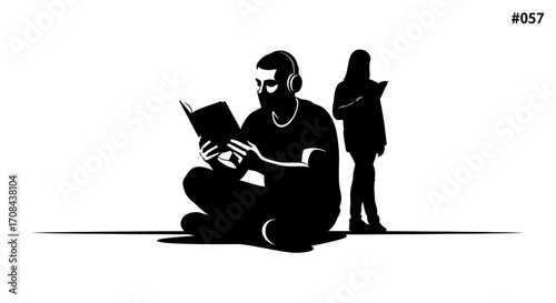 Focused man with headphones reading book while person stands nearby, symbolizing learning and concentration