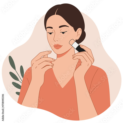 Young woman applying makeup with brush in minimalist setting  