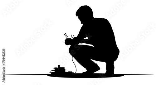Silhouette of man with wires and electronic equipment, representing innovation and creation in technology.