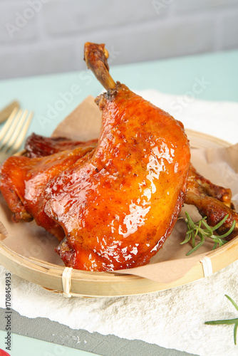 Roasted Chicken Thighs and Drumsticks with Crispy Golden Skin and Fresh Herbs on Wooden Plate
