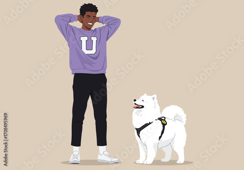 A smiling black man in a purple sweatshirt with a white u and black pants stands next to a white samoyed dog with a harness, against a tan background, showcasing a happy pet owner