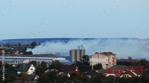 Industrial Disaster. A Factory Fire with Thick Blue Smoke and CO2. climate change, news reports on industrial accidents. A Building on Fire