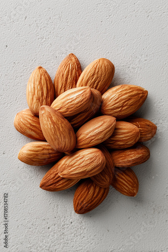 Overhead View of Handful of Almonds on White Surface