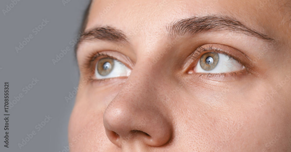 Fototapeta premium Woman with beautiful eyes on light grey background, closeup