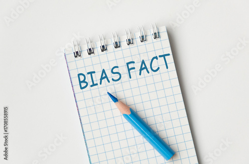 Wallpaper Mural A blue pencil is on a spiral bound notebook with the words Bias Fact written in blue. Torontodigital.ca
