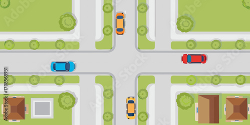 Top down view of cars driving through a suburban intersection with houses and trees