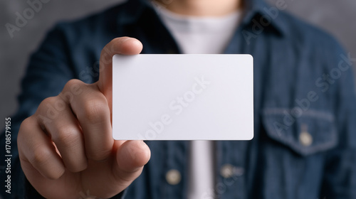 Wallpaper Mural A person is holding a white card in their hand Torontodigital.ca