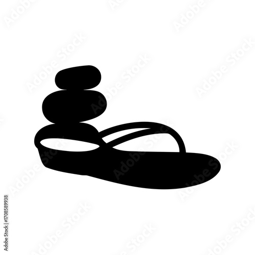 Zen stones balancing on a flip flop, symbol of relaxation and vacation