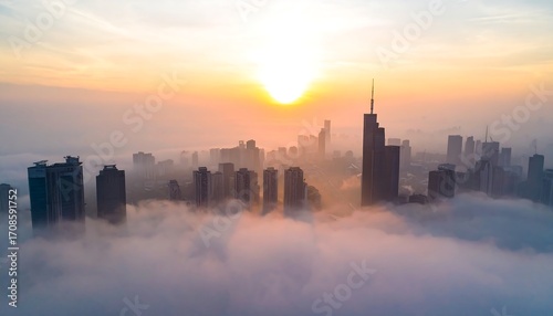 City skyline emerging from a dense fog at sunrise