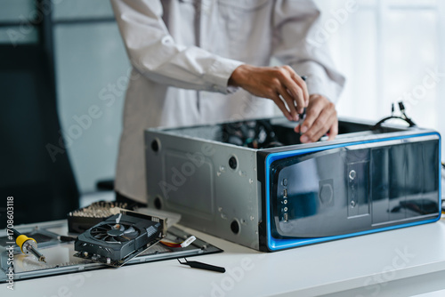 computer technician upgrades PC hardware in a workspace environment