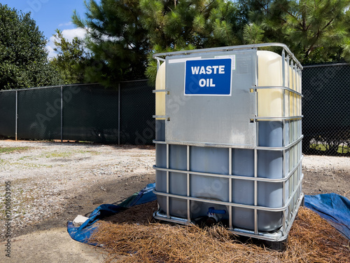 Waste oil recycling tank for used motor oil disposal at local trash dump recycle center.