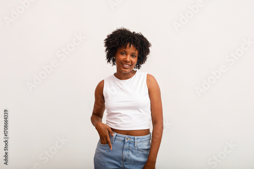 Woman Smiling Confidently in Casual Outfit Against White Background