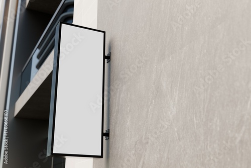 Blank vertical blade storefront sign on stucco wall mockup.