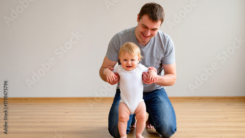 A loving father crouches down to help his smiling toddler take their first steps. The image captures a tender, joyful milestone in a child's development, highlighting the supportive role of a parent.