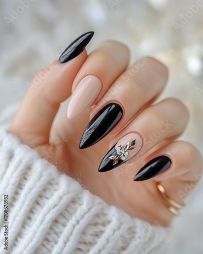 Stylish Black and Nude Nail Design With Embellishments on a Hand Wearing a Co...