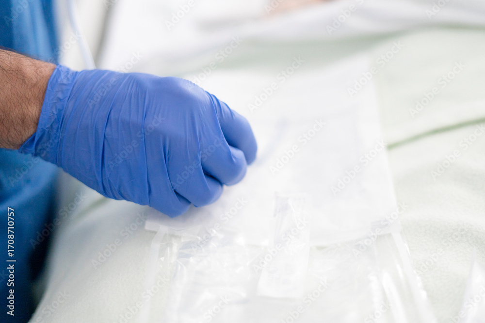 Fototapeta premium Surgeon preparing sterile drapes for medical procedure in operating room
